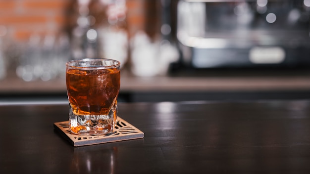 Glass of whiskey with ice cubes